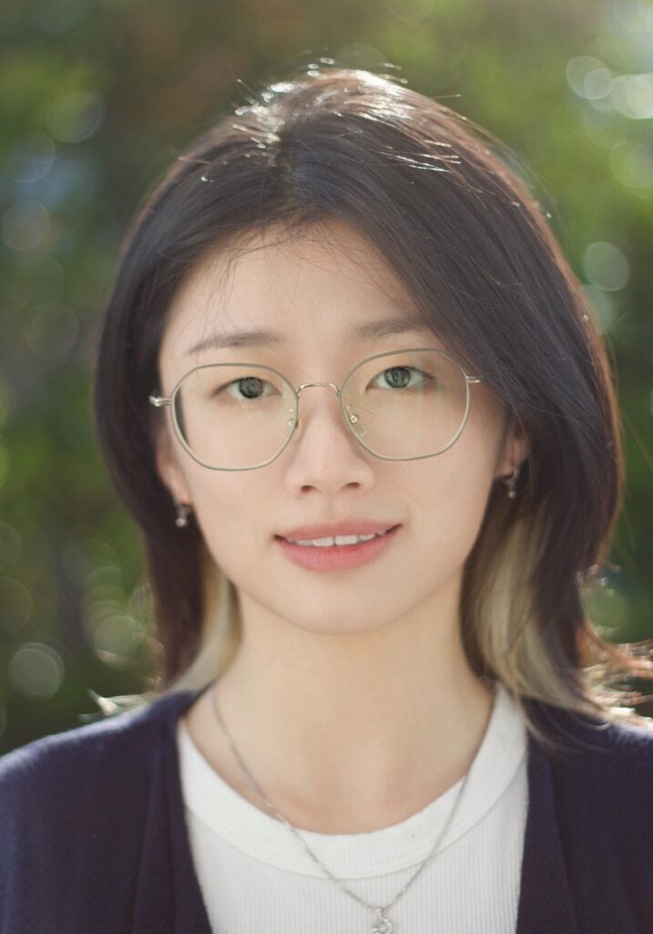 Professional portrait of Tanera van Diggelen, Psy.D., outdoors with greenery background.